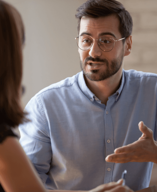 men with glasses raising hand
