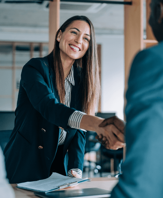 Smiling lady with brown hair shaking hands